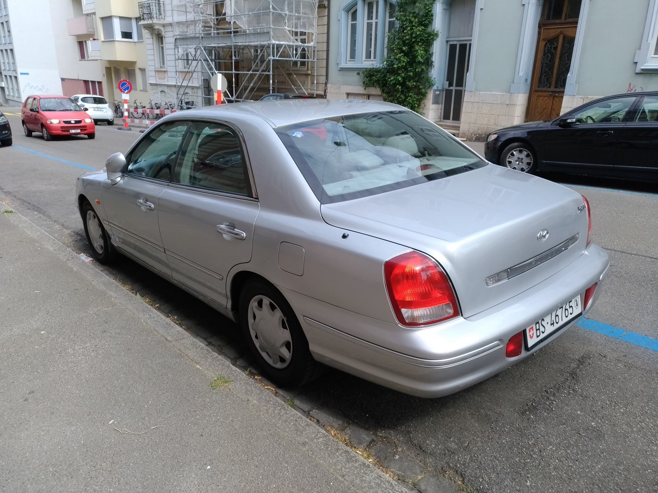 Silver sedan rear side view with classic early 2000s styling