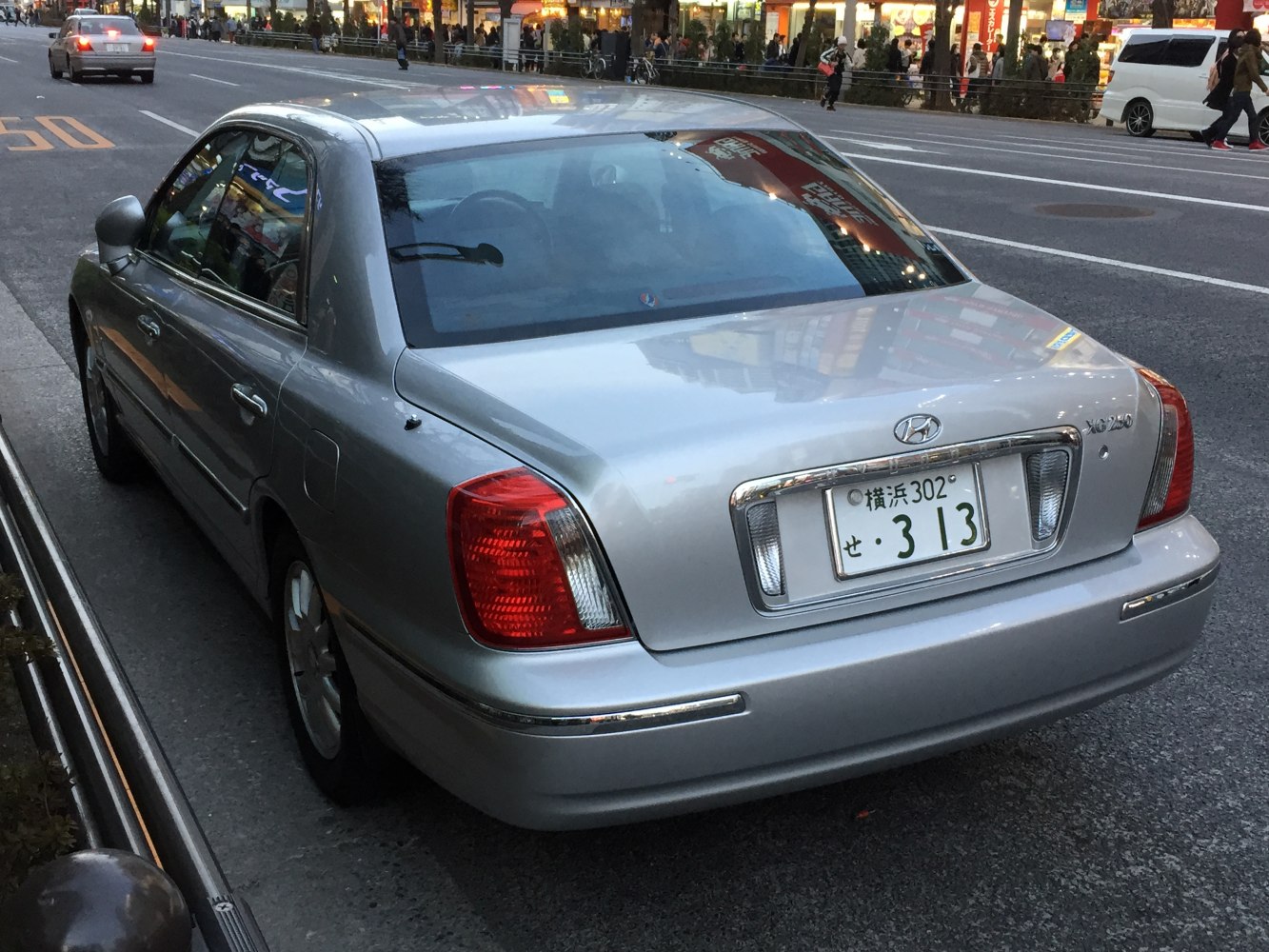 Rear view of a luxury sedan with classic taillights and chrome trim