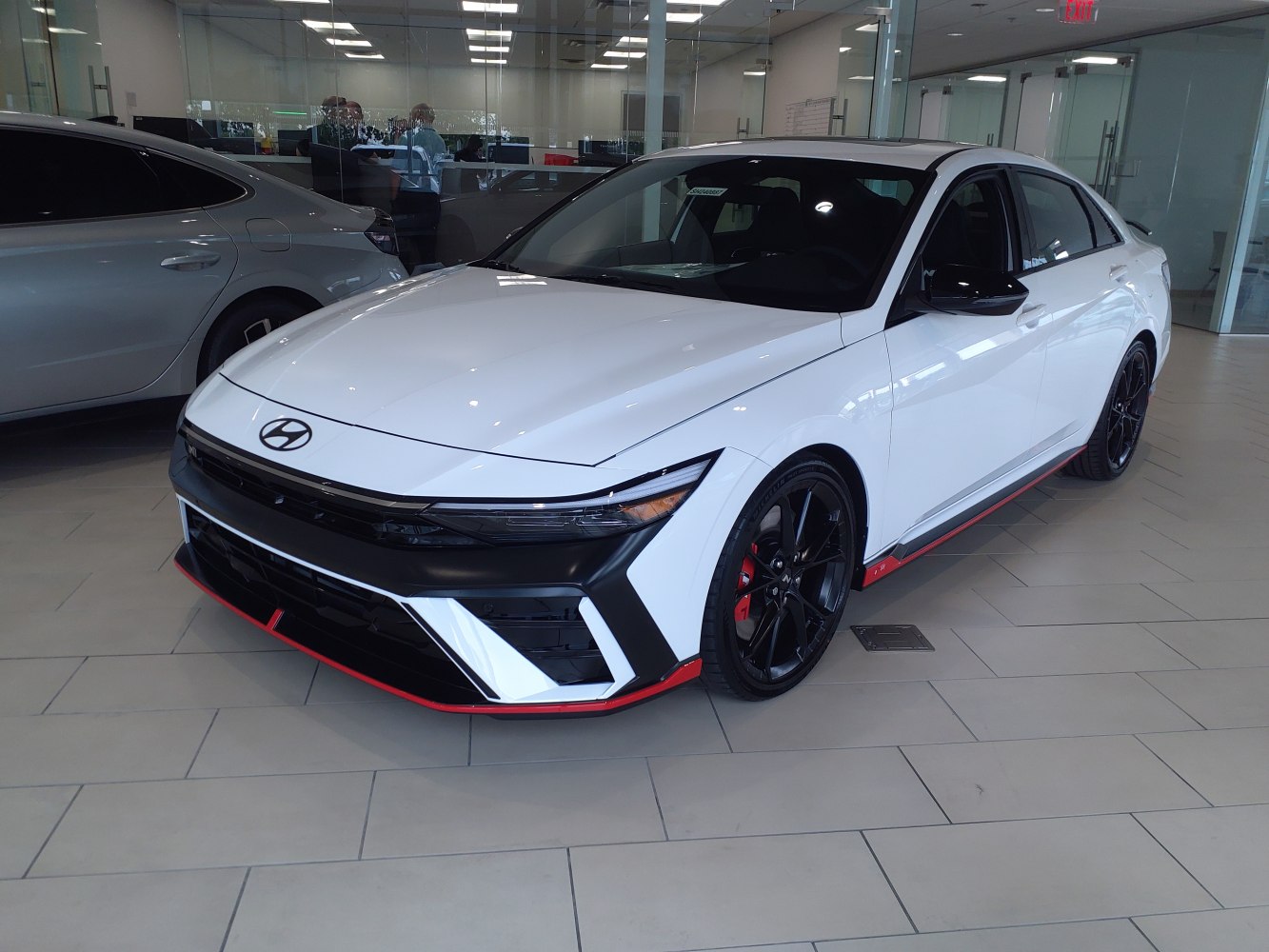 Sharp front fascia with black alloy wheels and red accents