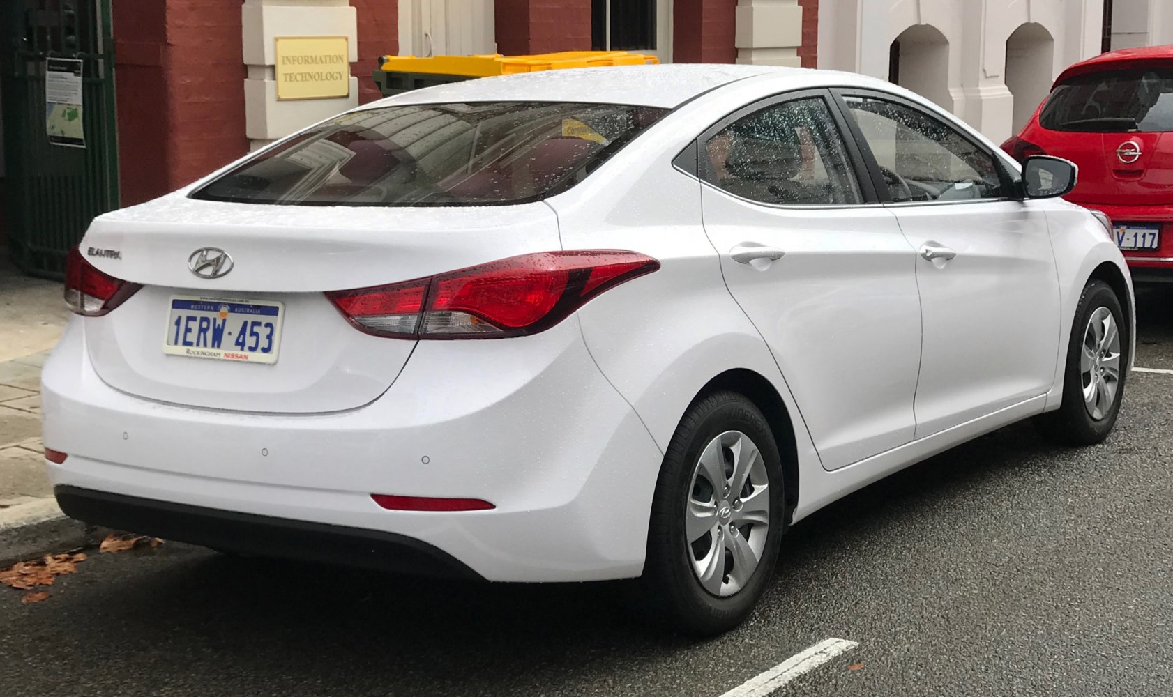Rear side view of sedan with distinct tail lights and aerodynamic design