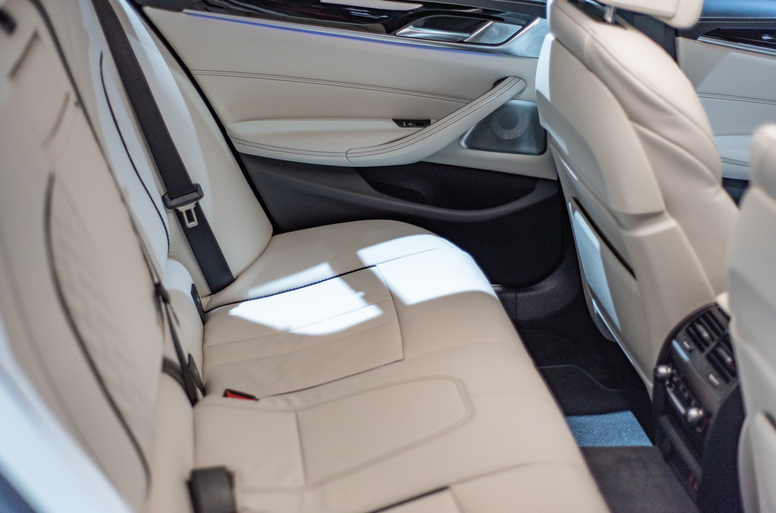 Luxury cream leather rear seats with rear air vents and detailed stitching