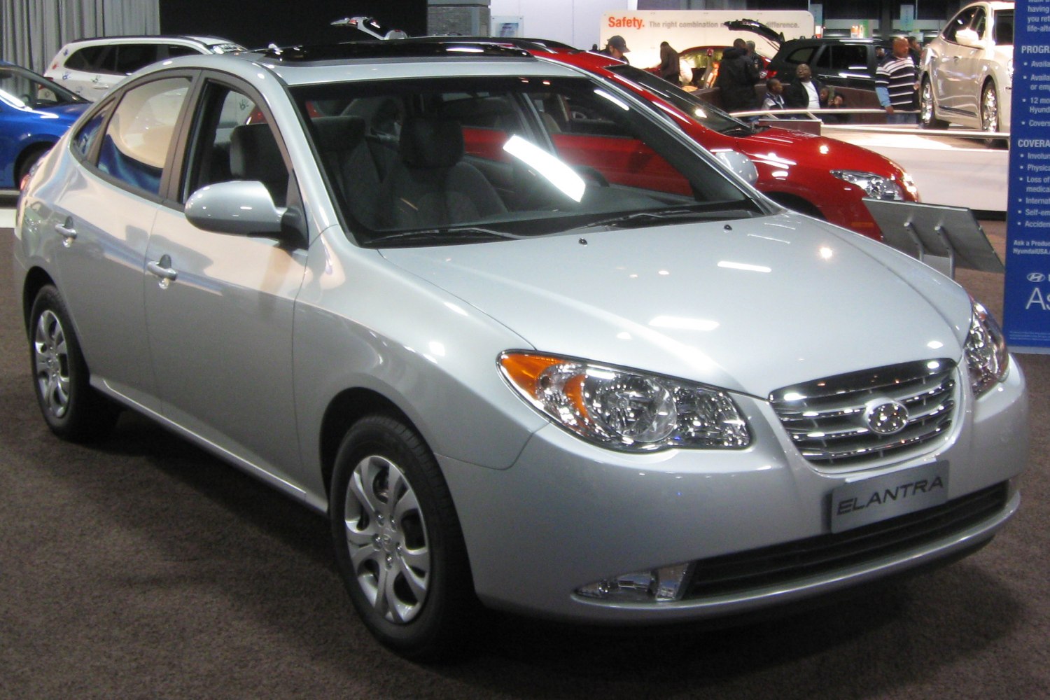 Silver sedan front side with alloy wheels and clear headlight design