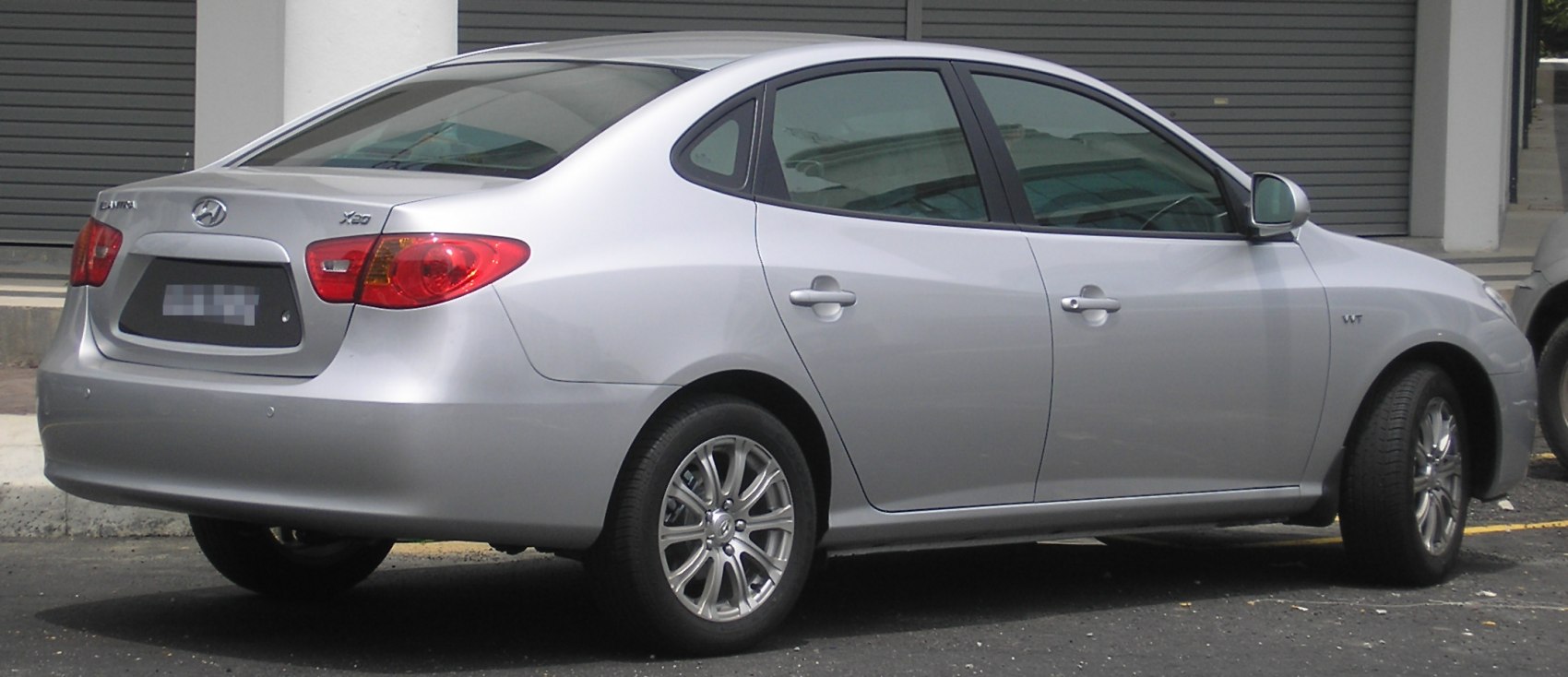 Silver hatchback rear side with taillights and alloy wheels