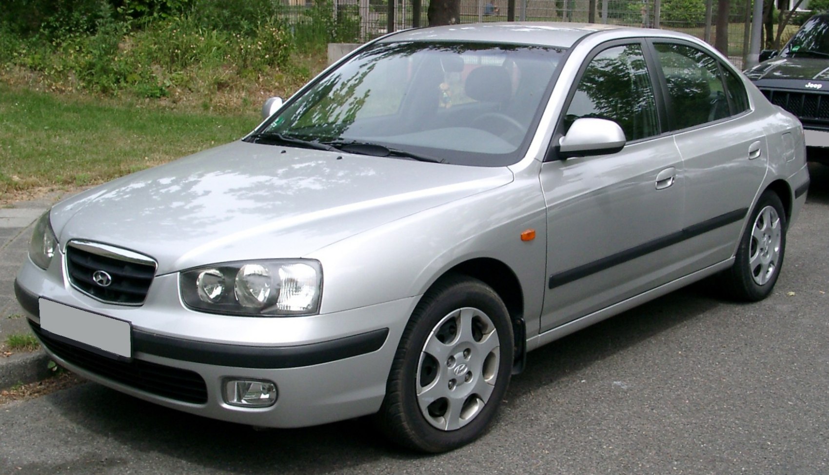Silver sedan with distinctive headlights and alloy wheels