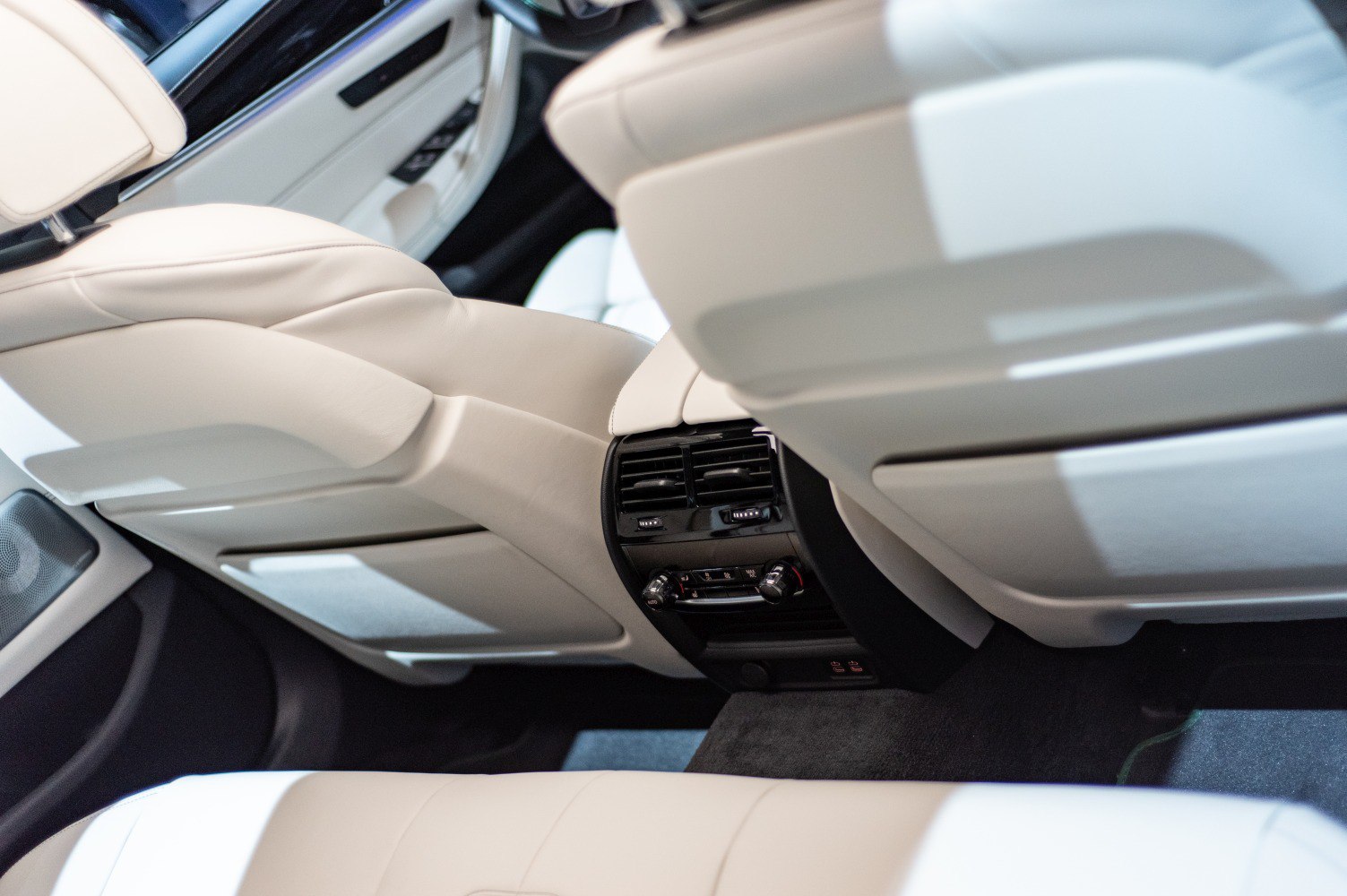 Rear climate control panel and beige leather backseat interiors