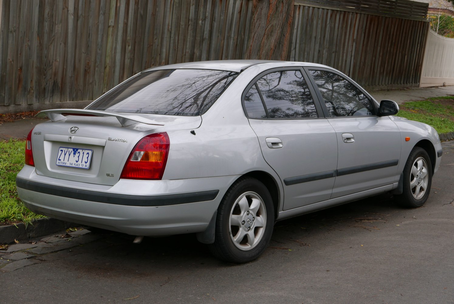 Silver sedan rear with spoiler and alloy wheels