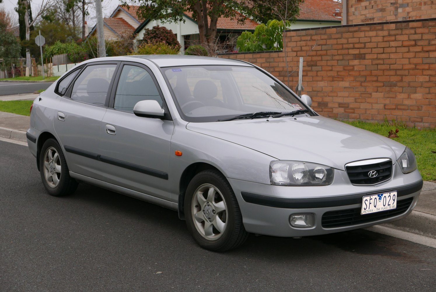 Front and side view of a hatchback with headlights and alloy wheels