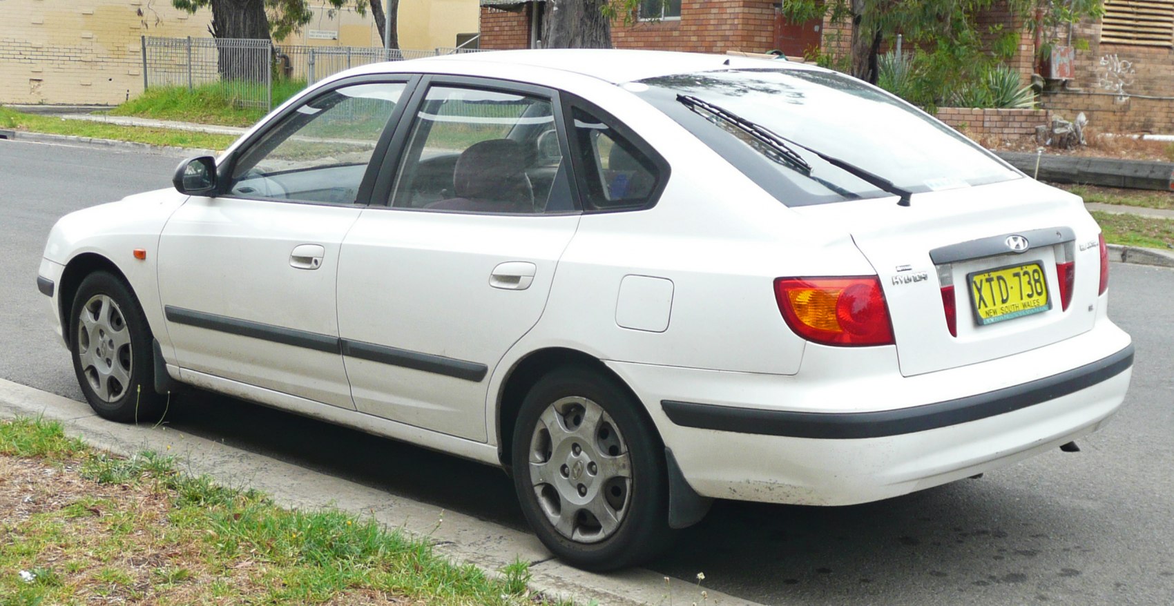 Rear side profile with hatchback design and alloy wheels