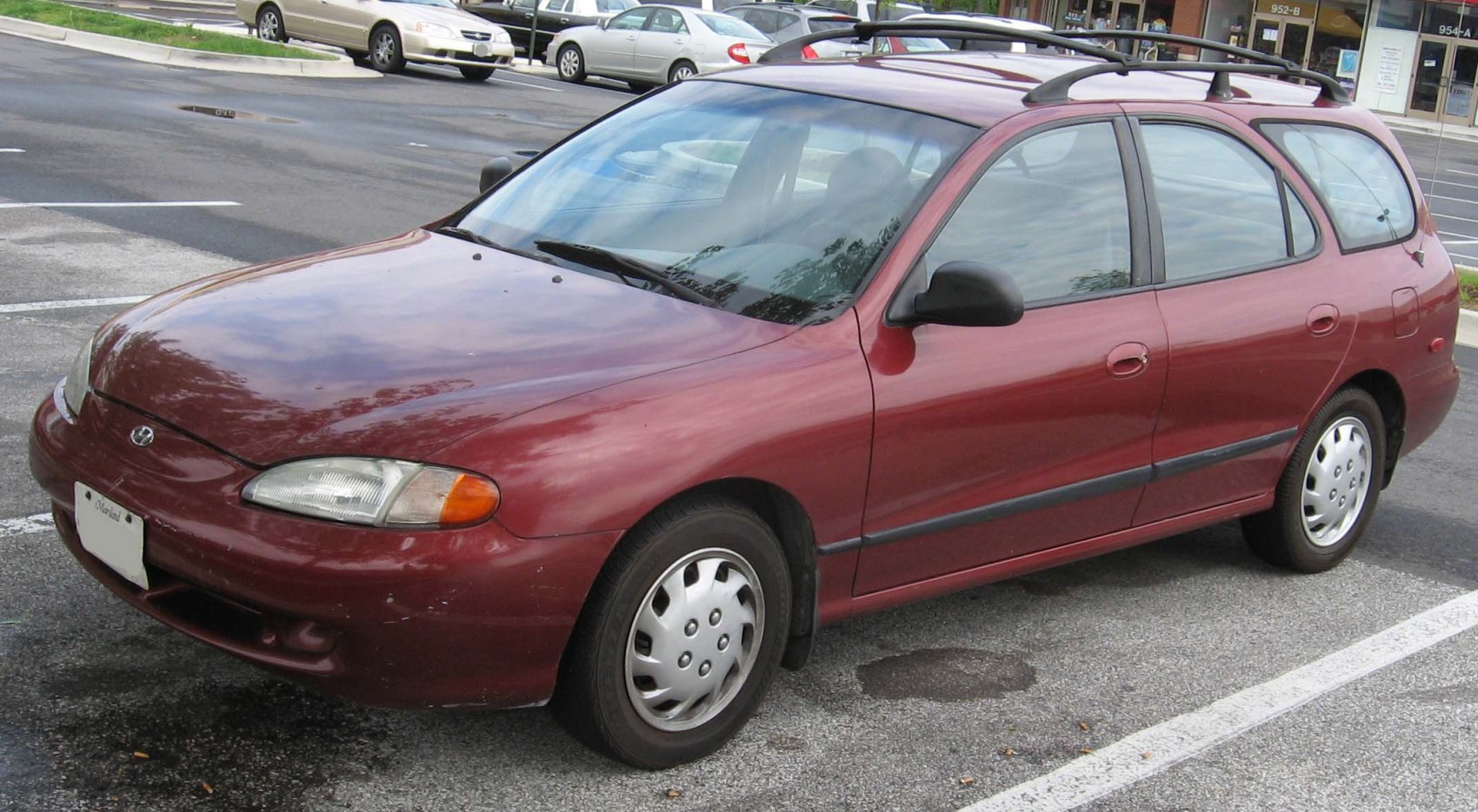 Compact red station wagon with roof rails and hatchback design