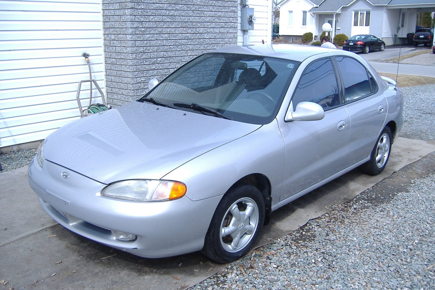 Silver four-door sedan with rounded design and alloy wheels