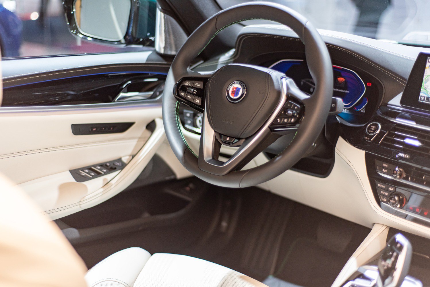Luxury car steering wheel and dashboard with digital display and controls