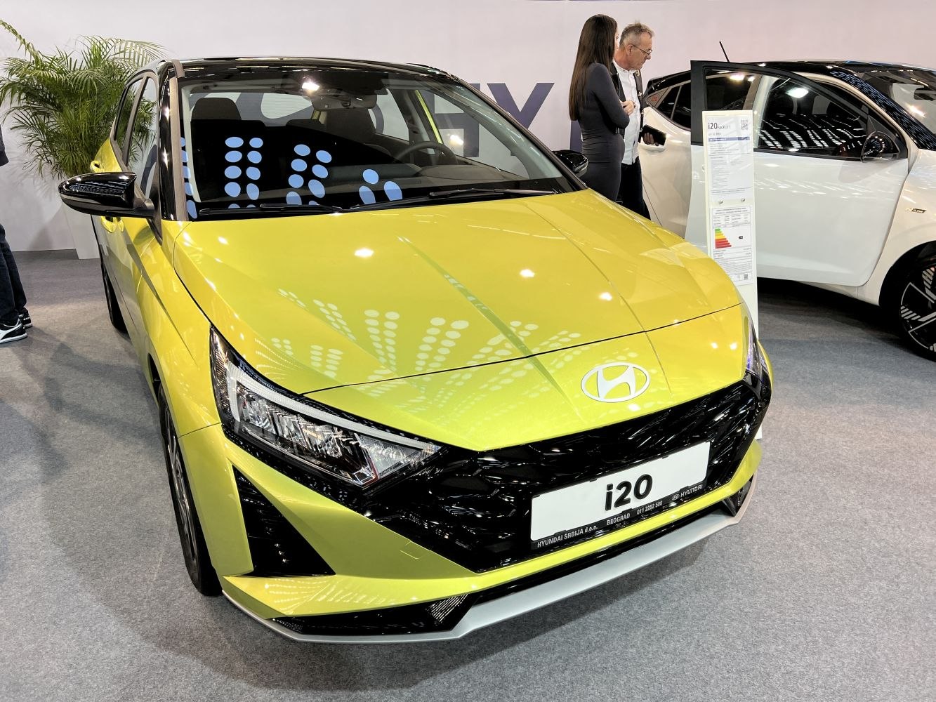 Angular headlights and bold black grille on a modern hatchback front.