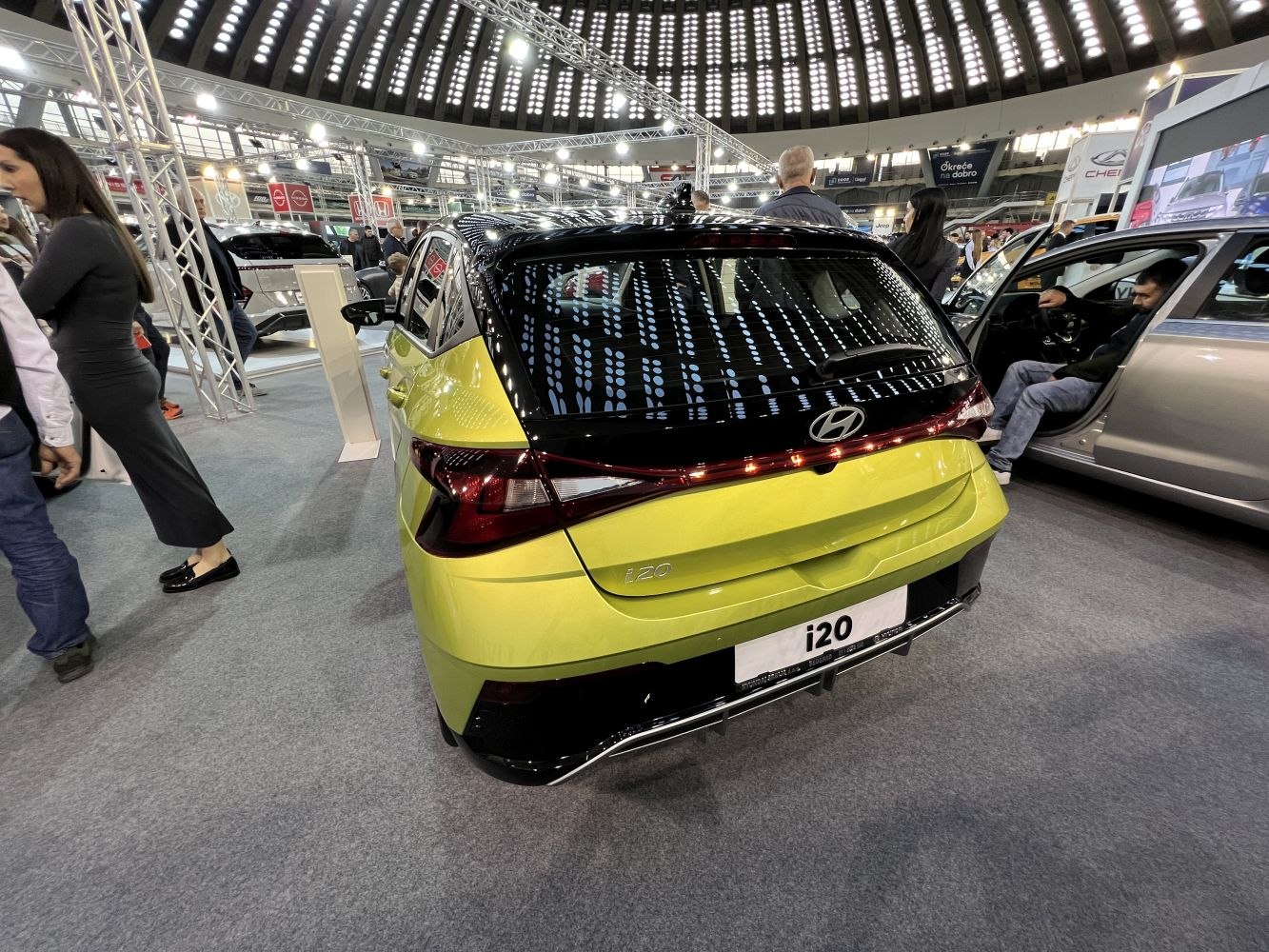 Rear view of a hatchback with modern connected taillights and two-tone color.