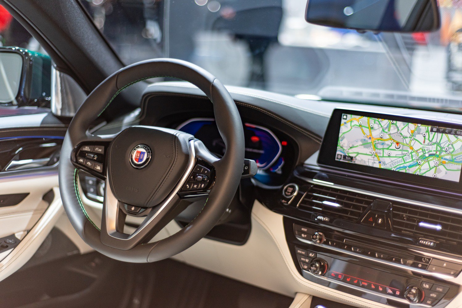Luxury steering wheel with multi-function controls and digital dashboard with navigation screen