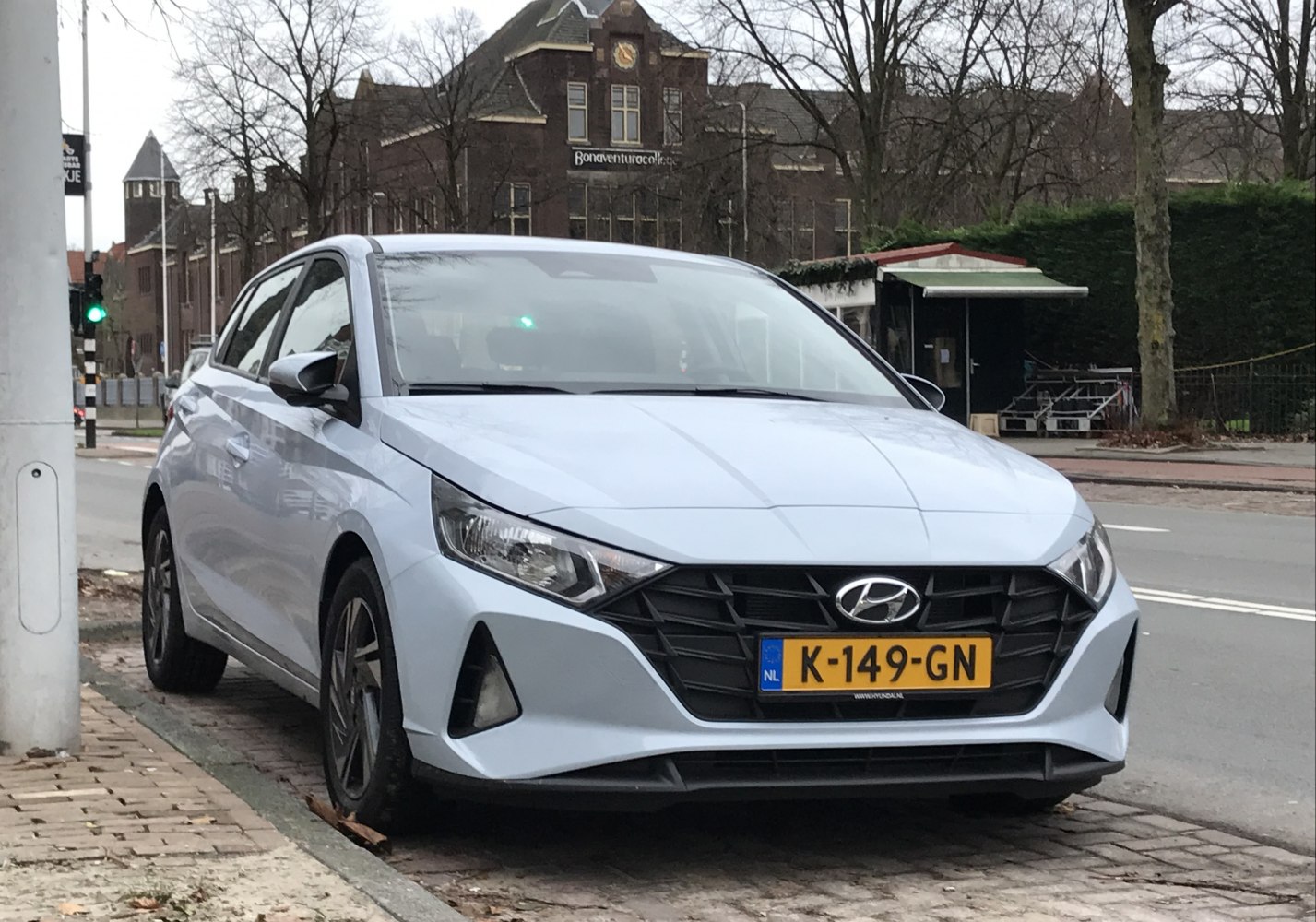 Front view with angular headlights and large black grille.