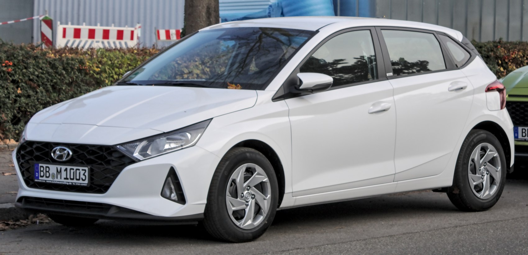 White compact hatchback with angular headlights and honeycomb front grille