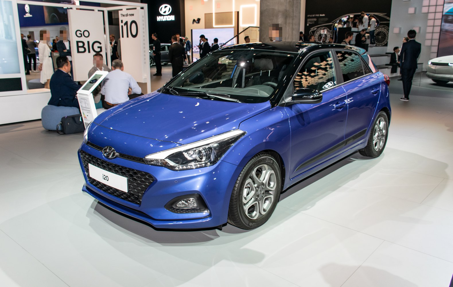 Front angle view showcasing headlights and grille of blue hatchback