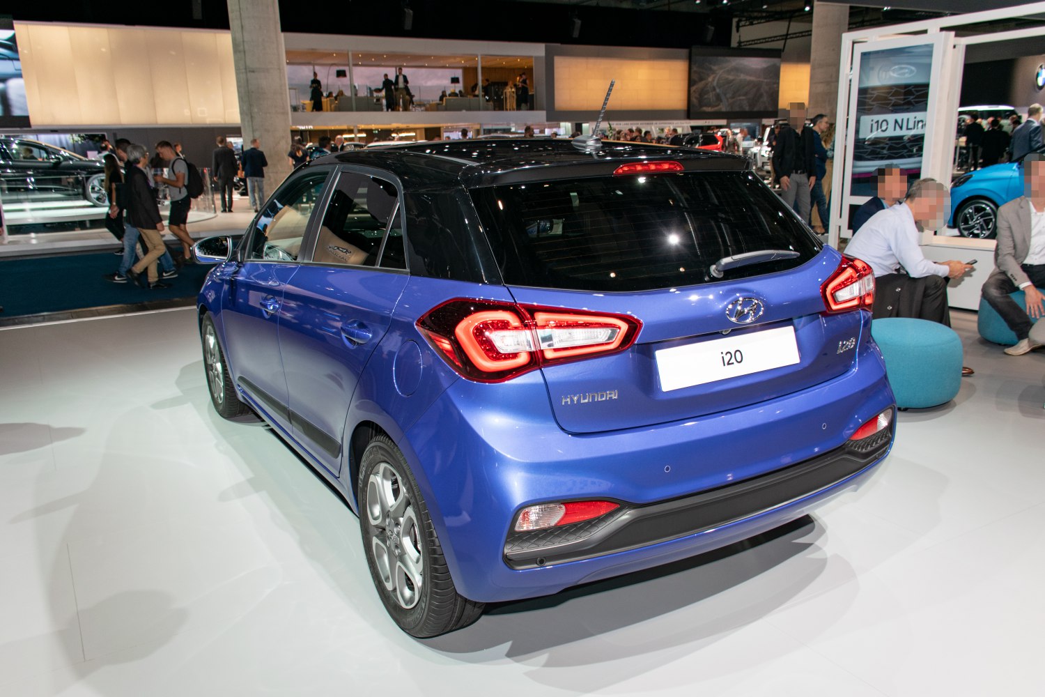 Rear view with distinctive tail lights and black roof on hatchback.