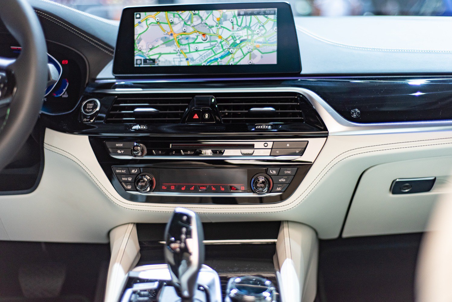 Car interior with digital navigation screen and dual-zone climate control