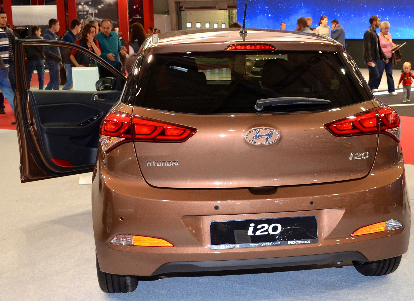 Rear view of hatchback car with open door and modern taillights
