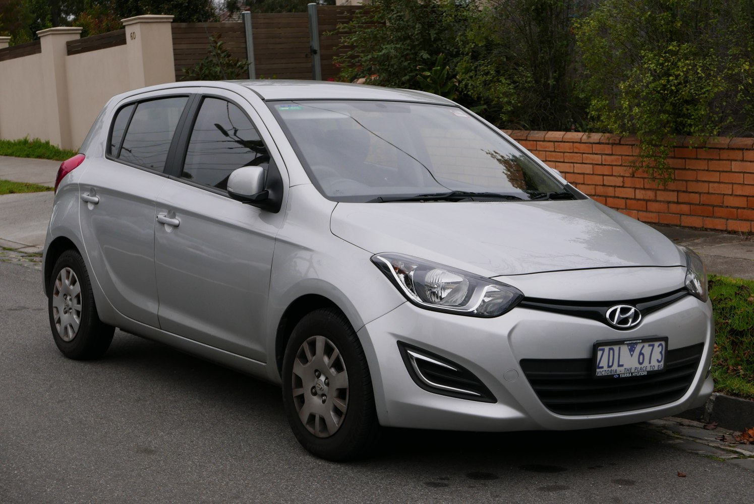 Silver hatchback with modern headlight and grille design
