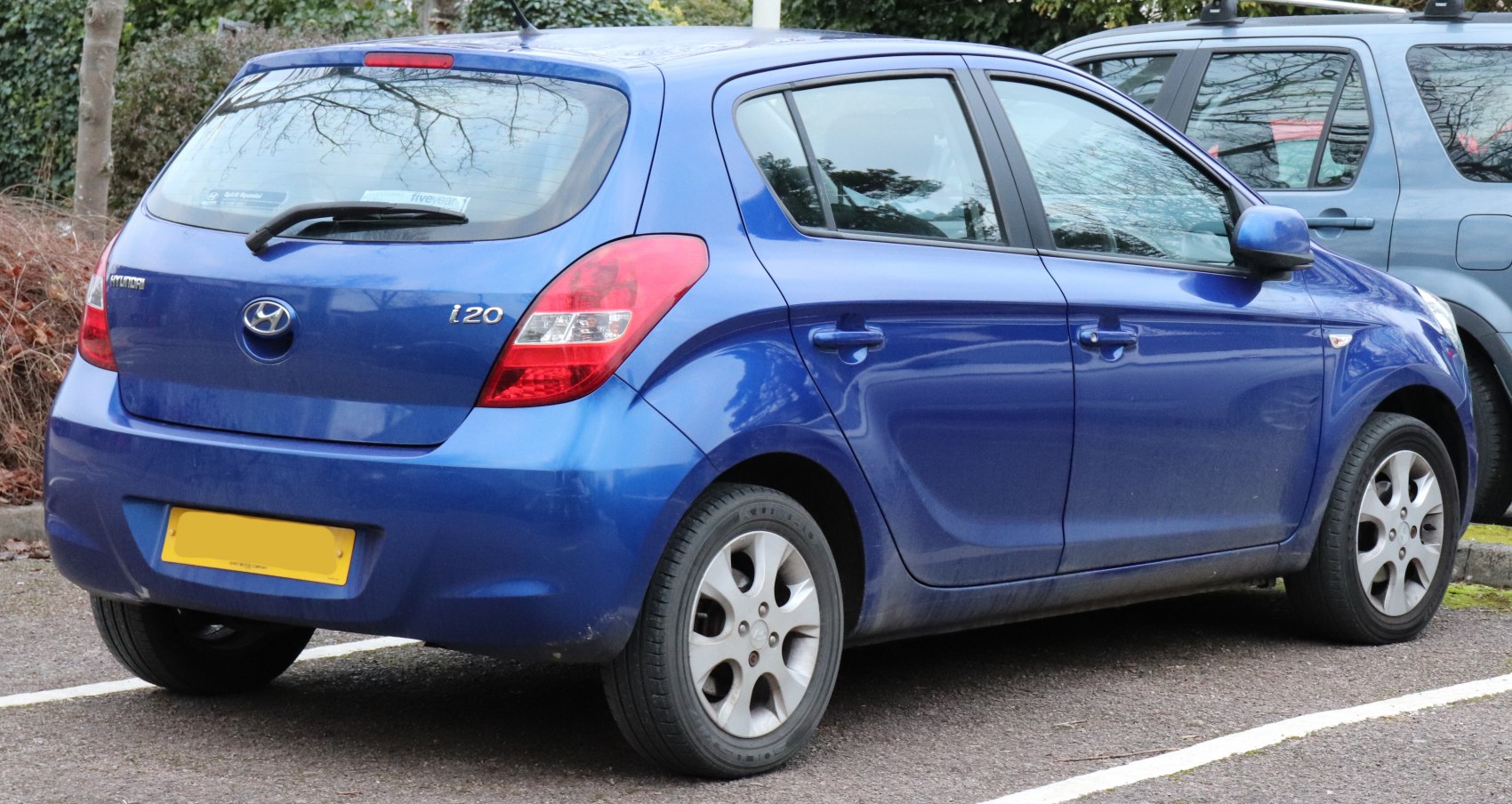 Rear and side view of a blue 5-door hatchback with distinctive tail lights.