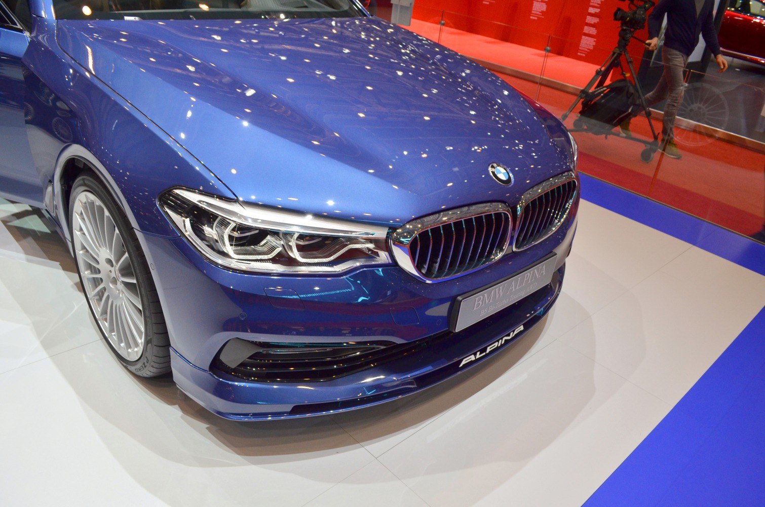 Close-up of front grille and LED headlight design with blue paint.
