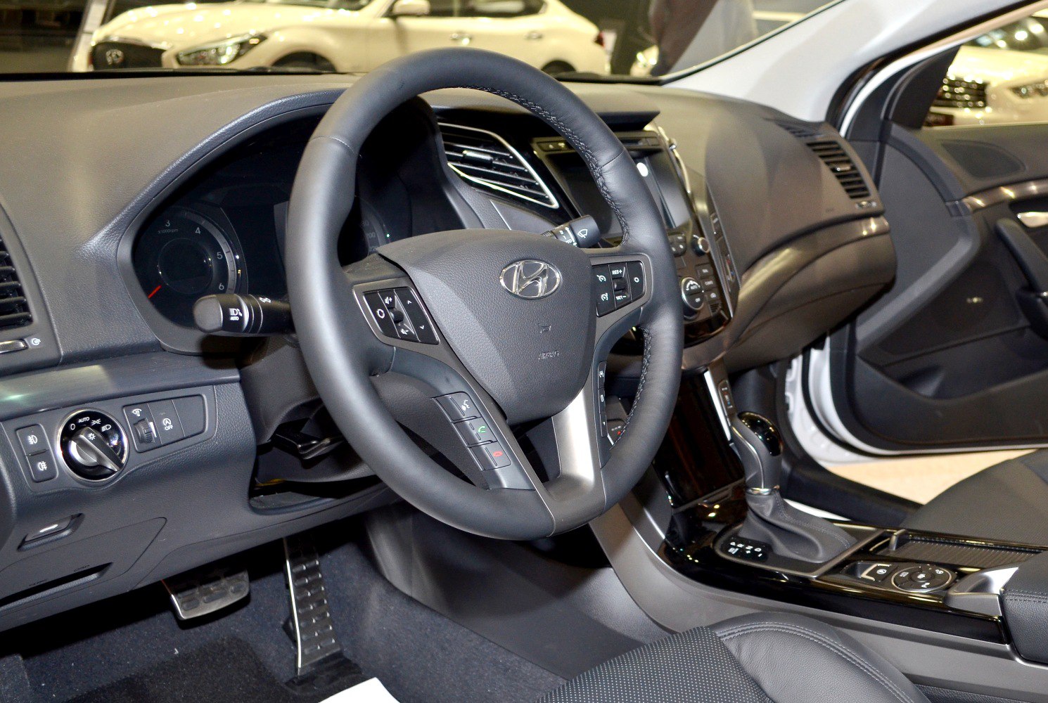 Steering wheel and dashboard with gear shift console in car interior
