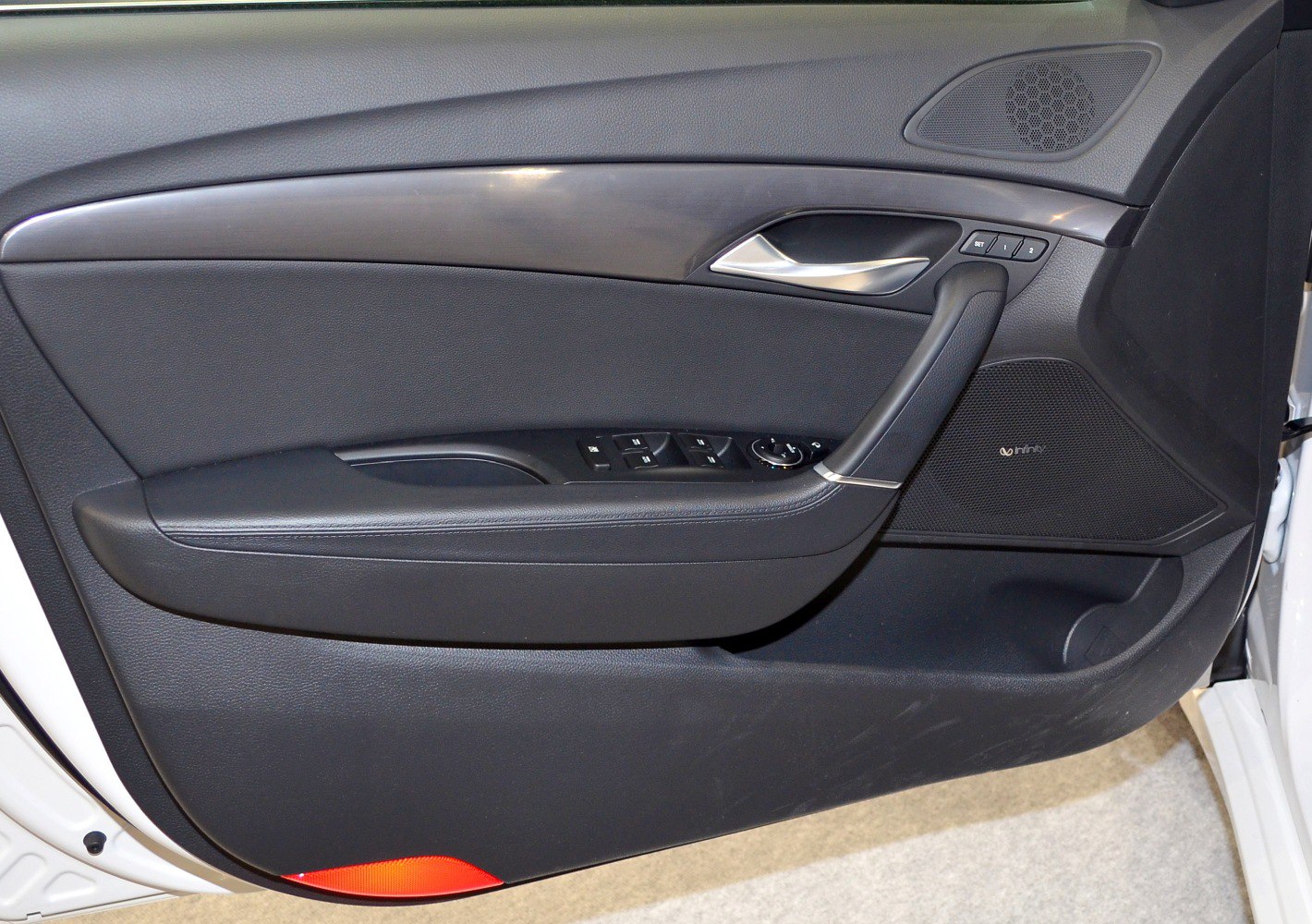 Interior door panel with control buttons and speaker