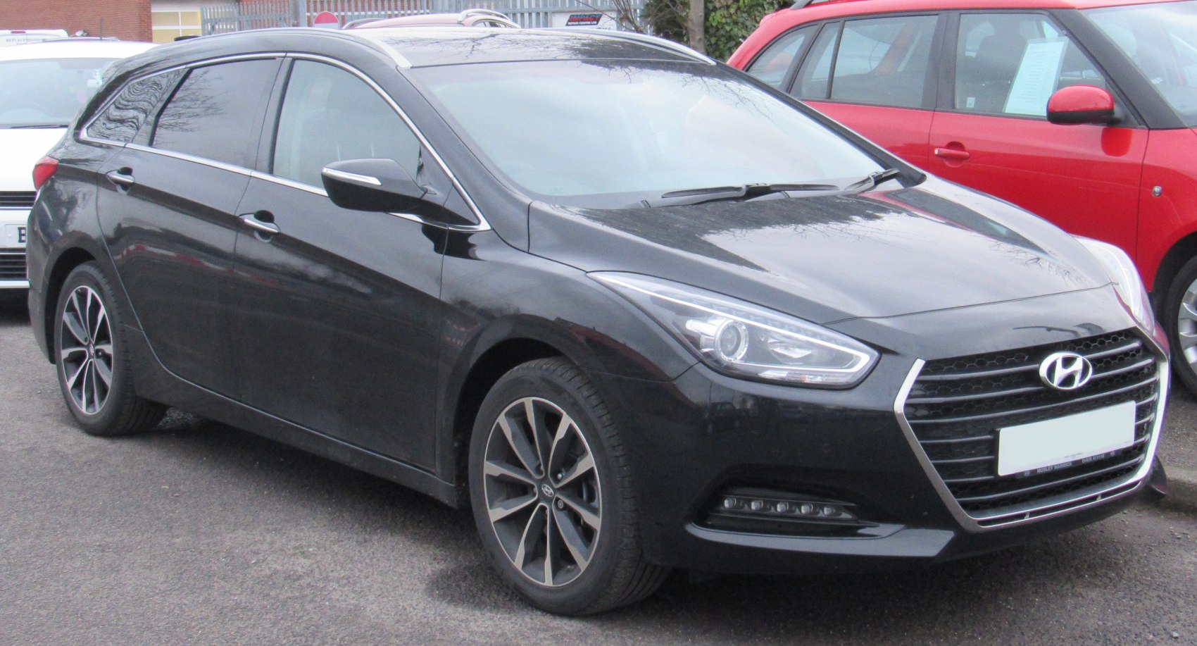 Front and side view with sleek headlights and alloy wheels