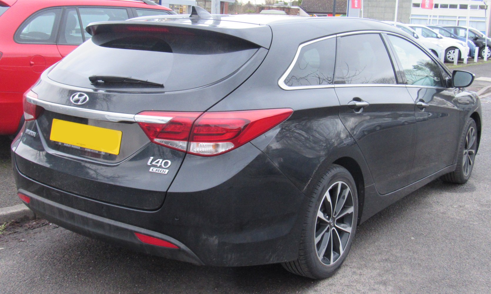 Rear view of estate wagon with sleek taillights and roof spoiler