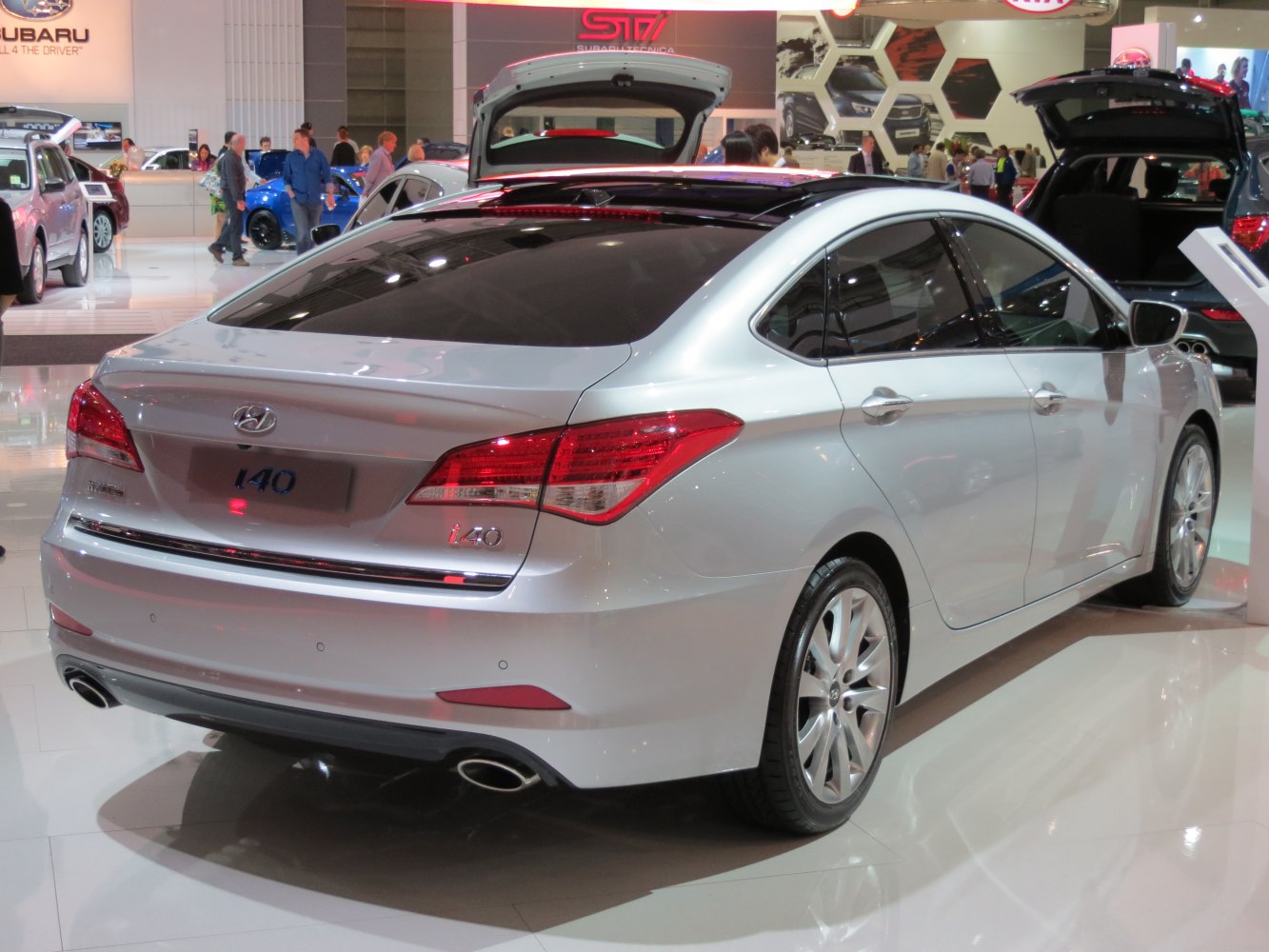 Rear side view of a silver sedan with dual exhaust and distinct tail lights