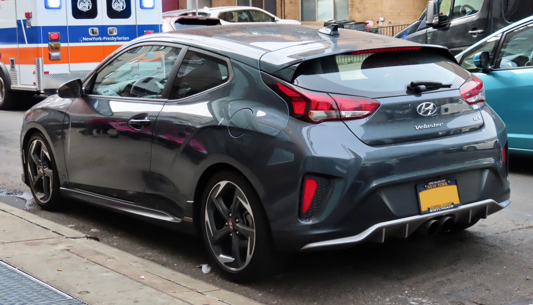 Sporty rear and side view of a hatchback with dual exhaust and distinctive taillights
