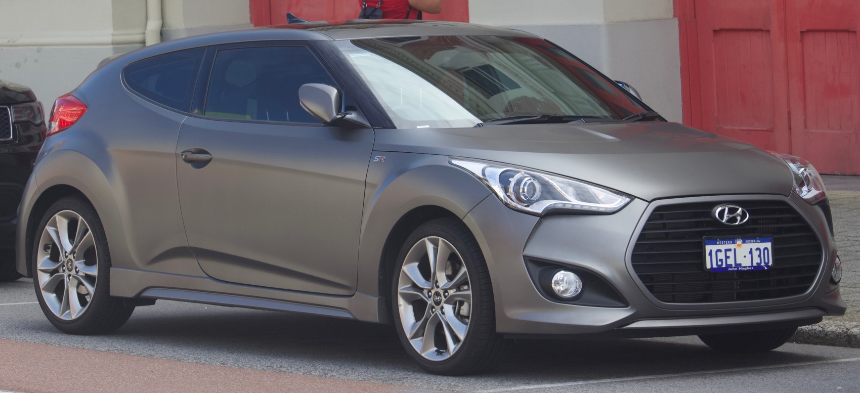 Sporty hatchback front and side profile with distinctive headlights and alloy wheels