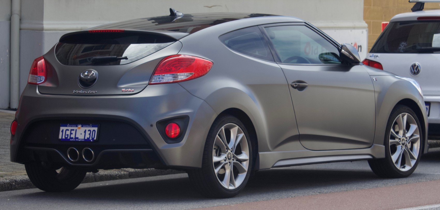 Rear view sporty hatchback with twin exhausts and distinctive taillights
