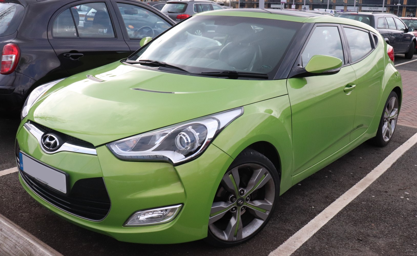 Bright green sport hatchback with aggressive front and alloy wheels