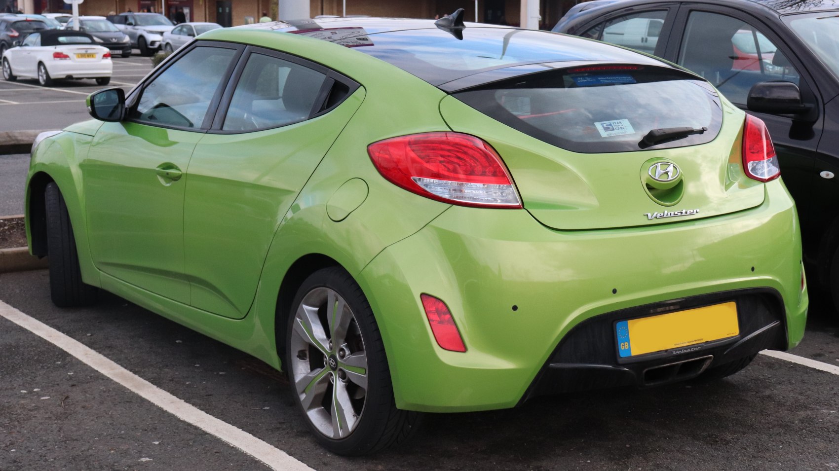 Green modern hatchback with sporty rear design and alloy wheels