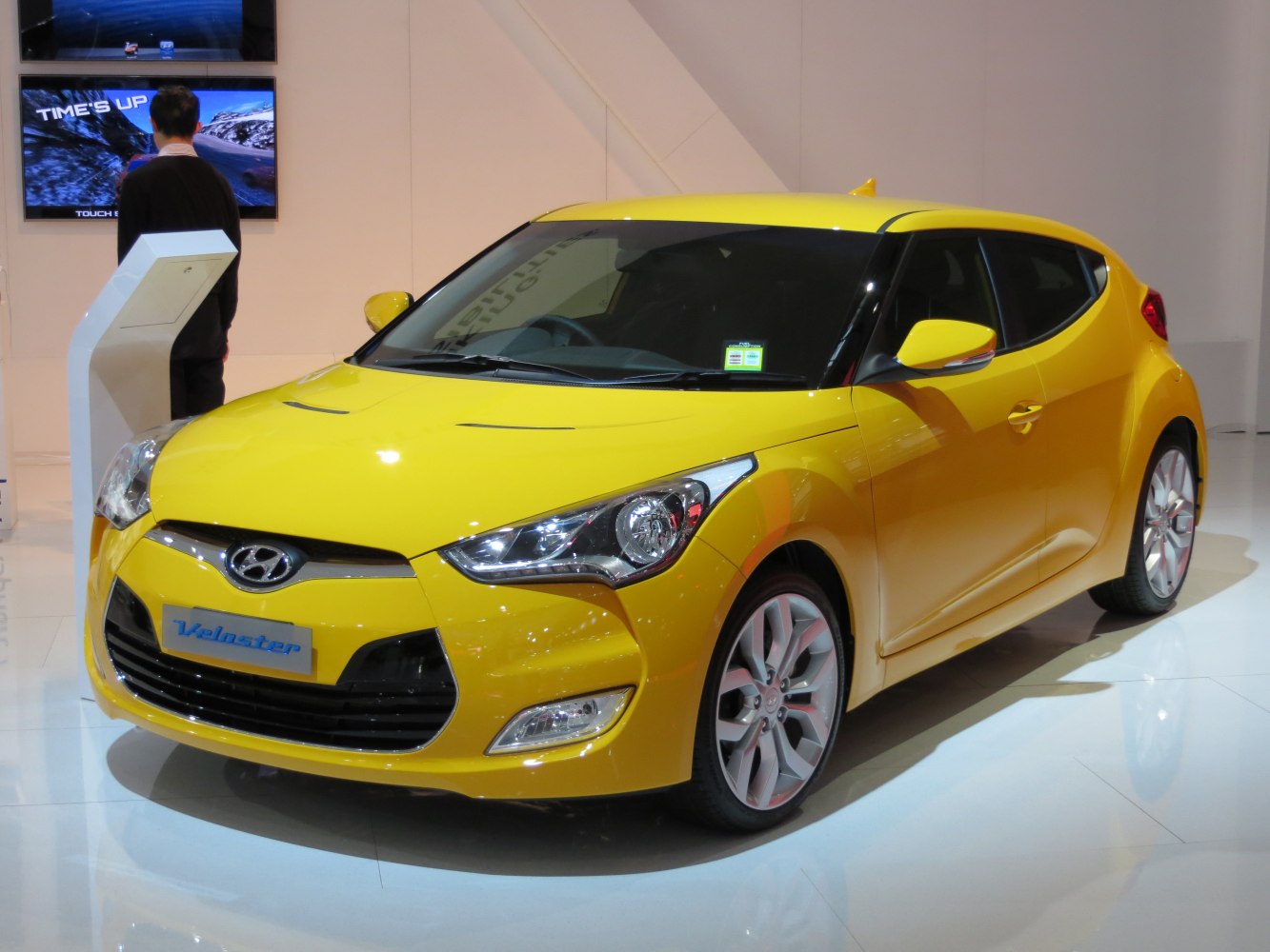 Bright yellow compact hatchback with aggressive front and sporty side profile