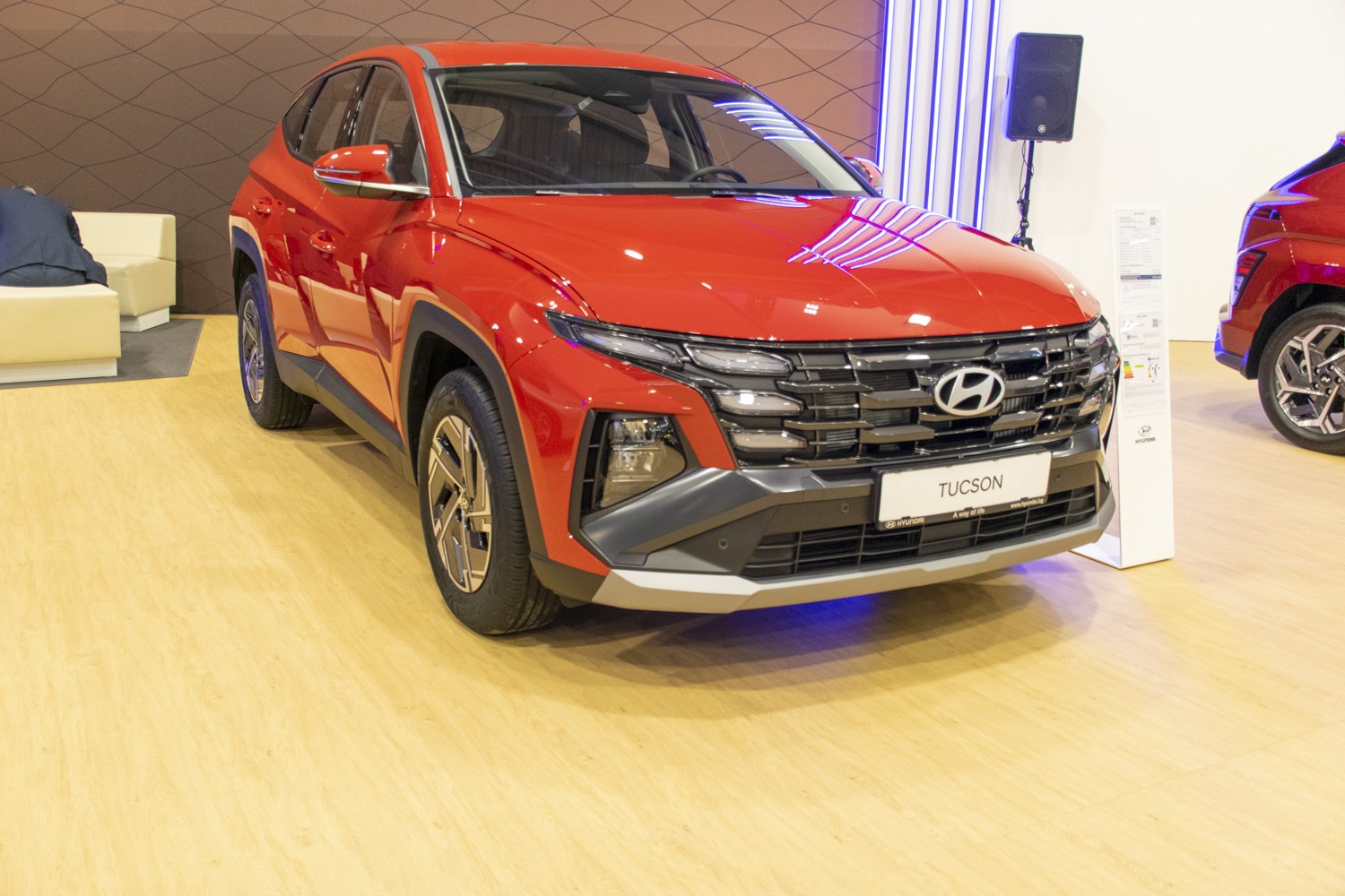 Sharp LED headlights and bold front grille with red SUV body