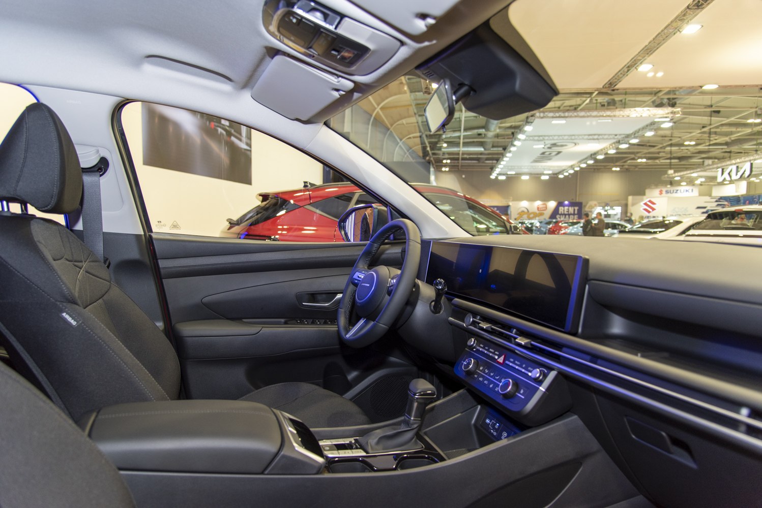 Interior cockpit showing dashboard, steering wheel, and infotainment display
