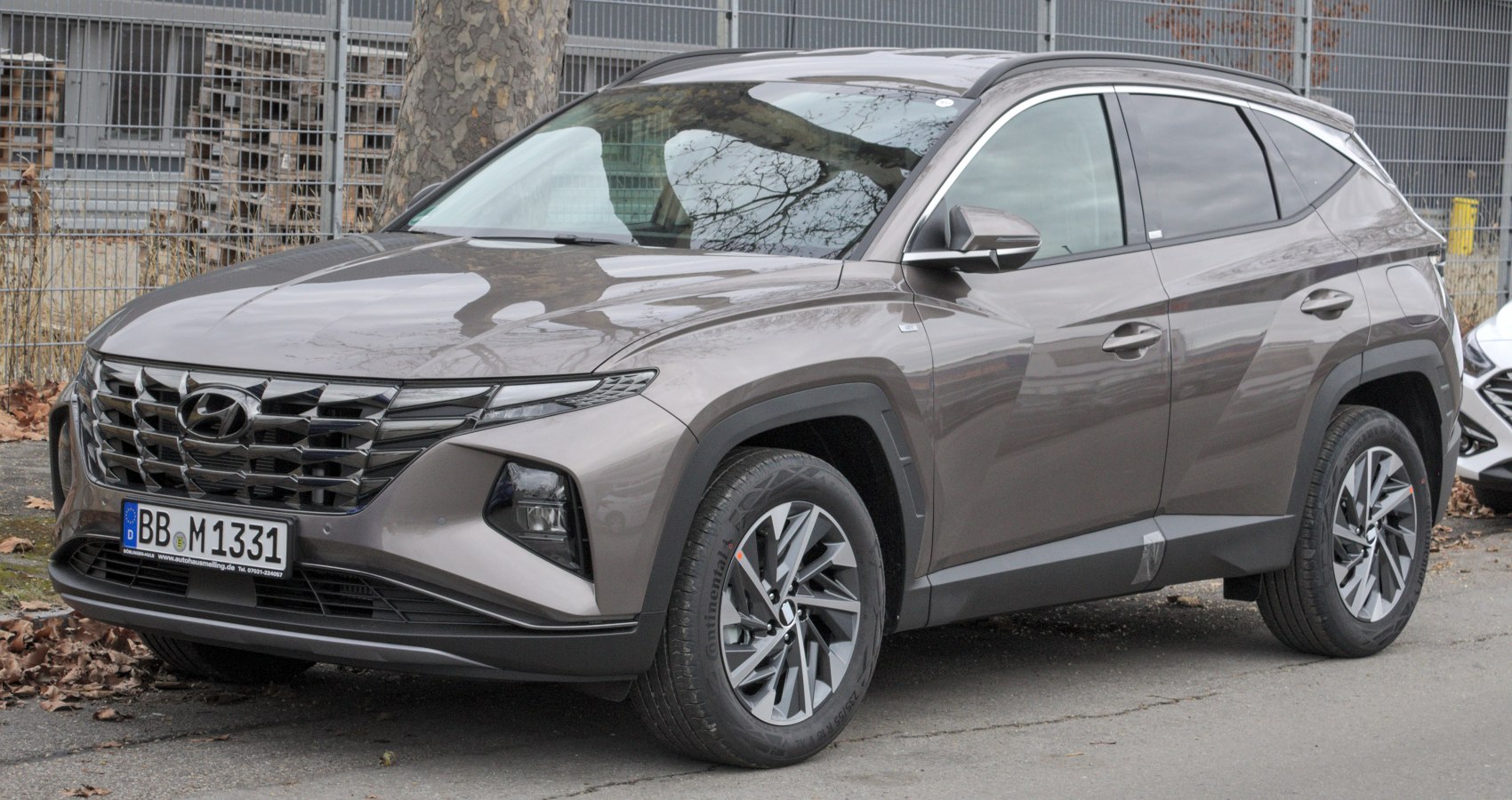 Front side view of an SUV with unique grille and alloy wheels