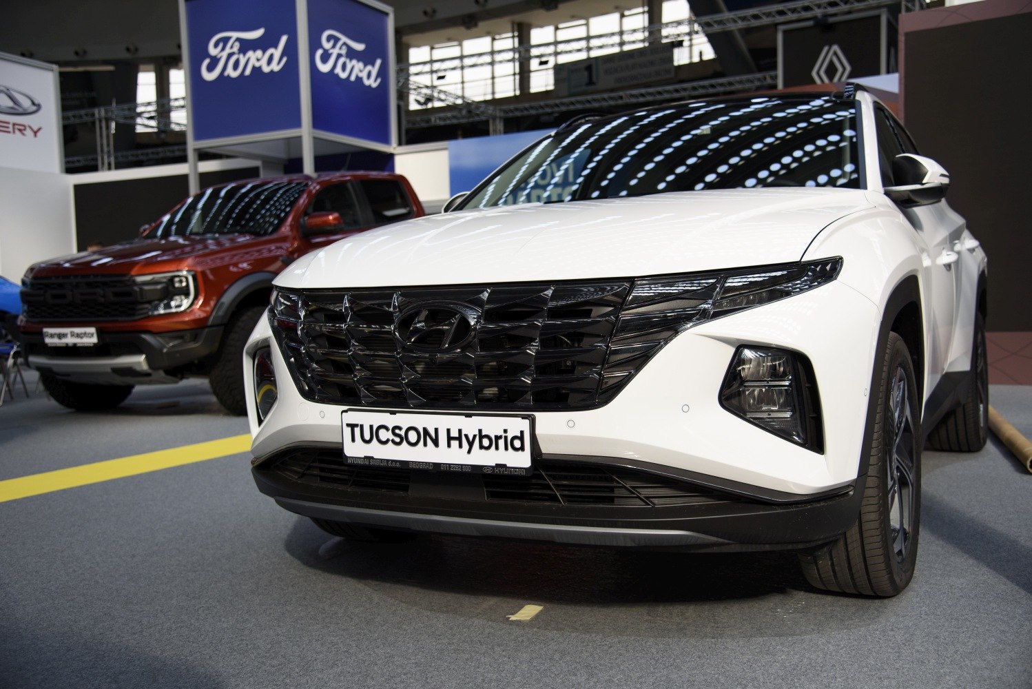 Close-up front view of sleek hybrid SUV grille and headlights
