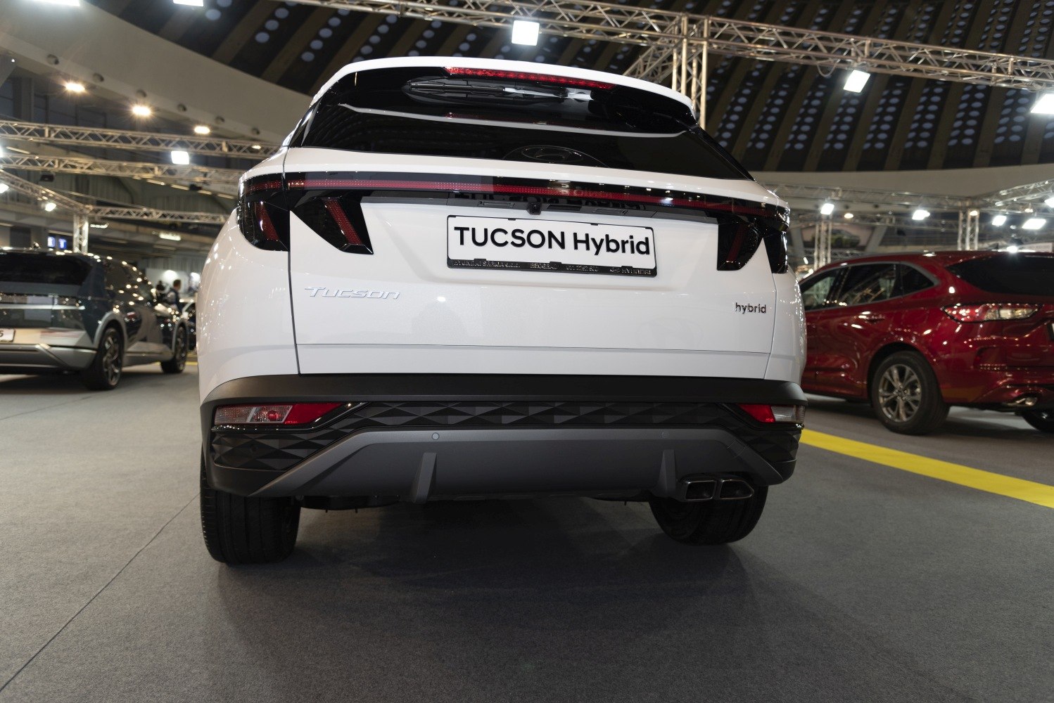 Rear view of a hybrid SUV highlighting rear lights and bumper design