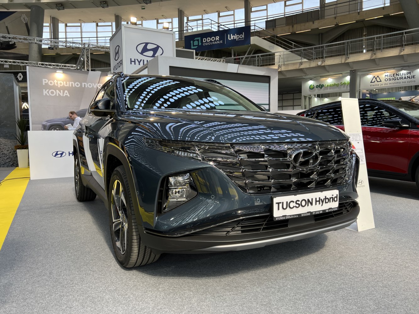 Front close-up of hybrid SUV with prominent grille and LED daytime running lights