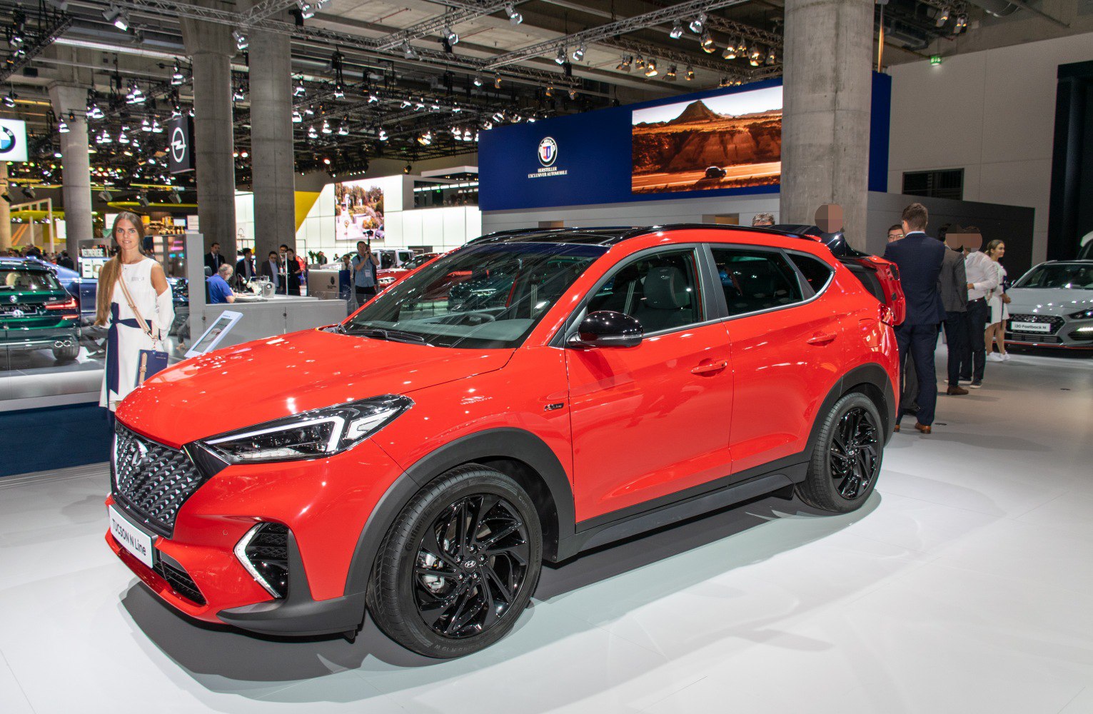 Red SUV with black alloy wheels and sporty front design