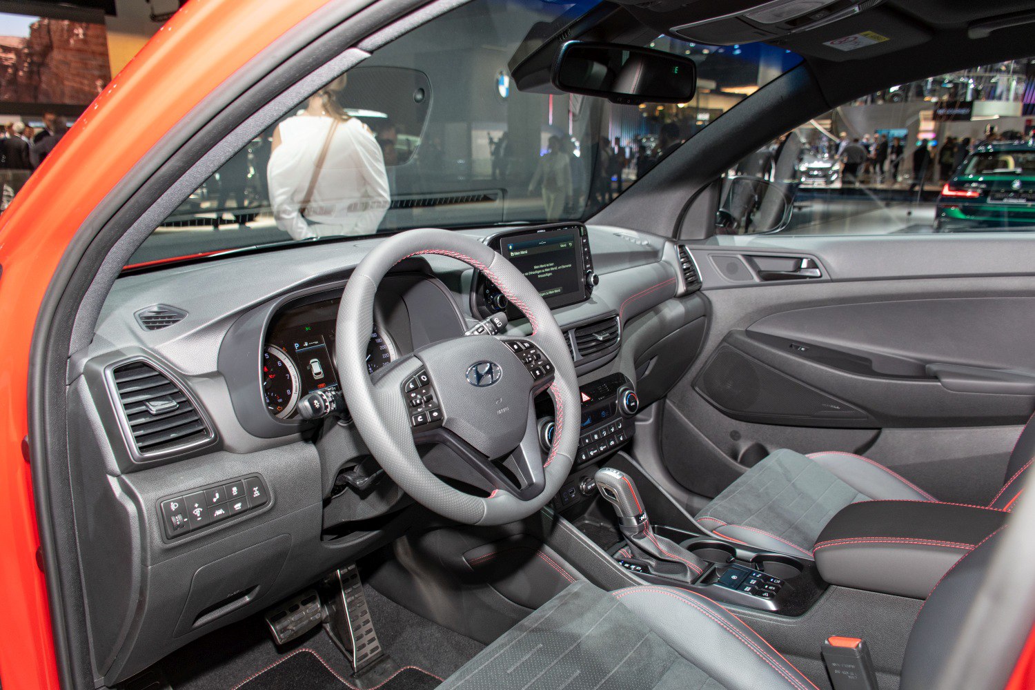 Dashboard, steering wheel, and central console with infotainment screen and gearshift