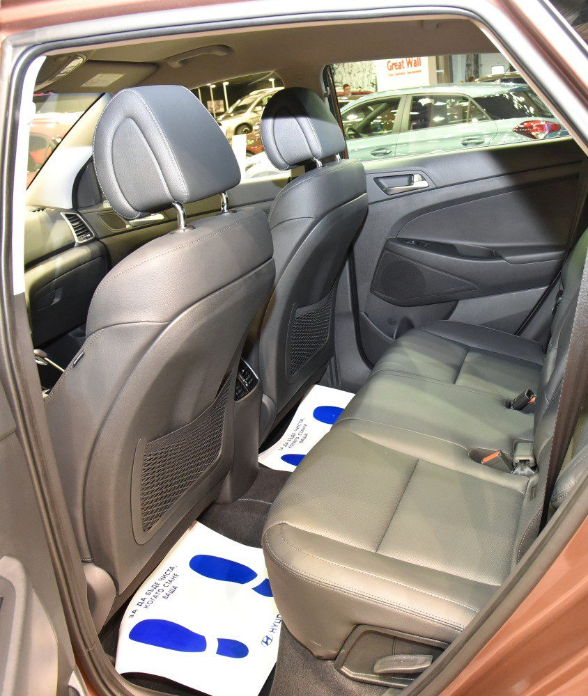Rear seating area with black leather upholstery and spacious legroom