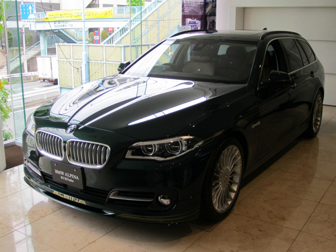 Touring wagon with Alpina aerodynamic front splitter and multi-spoke alloy wheels.