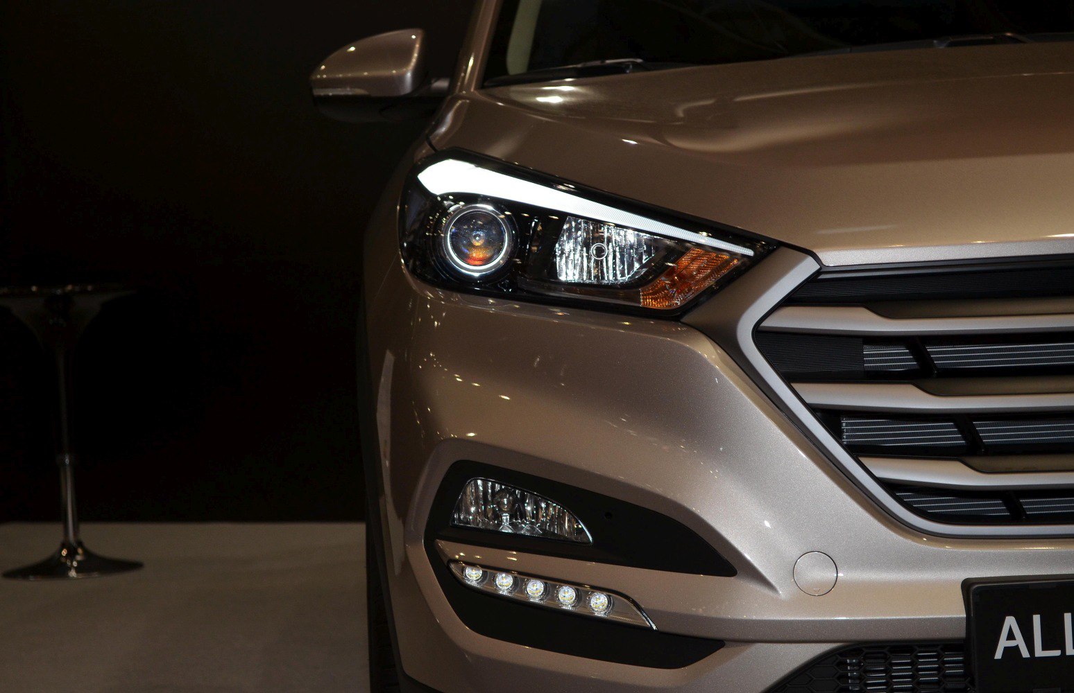 Close-up of front headlight and grille with LED daytime running lights