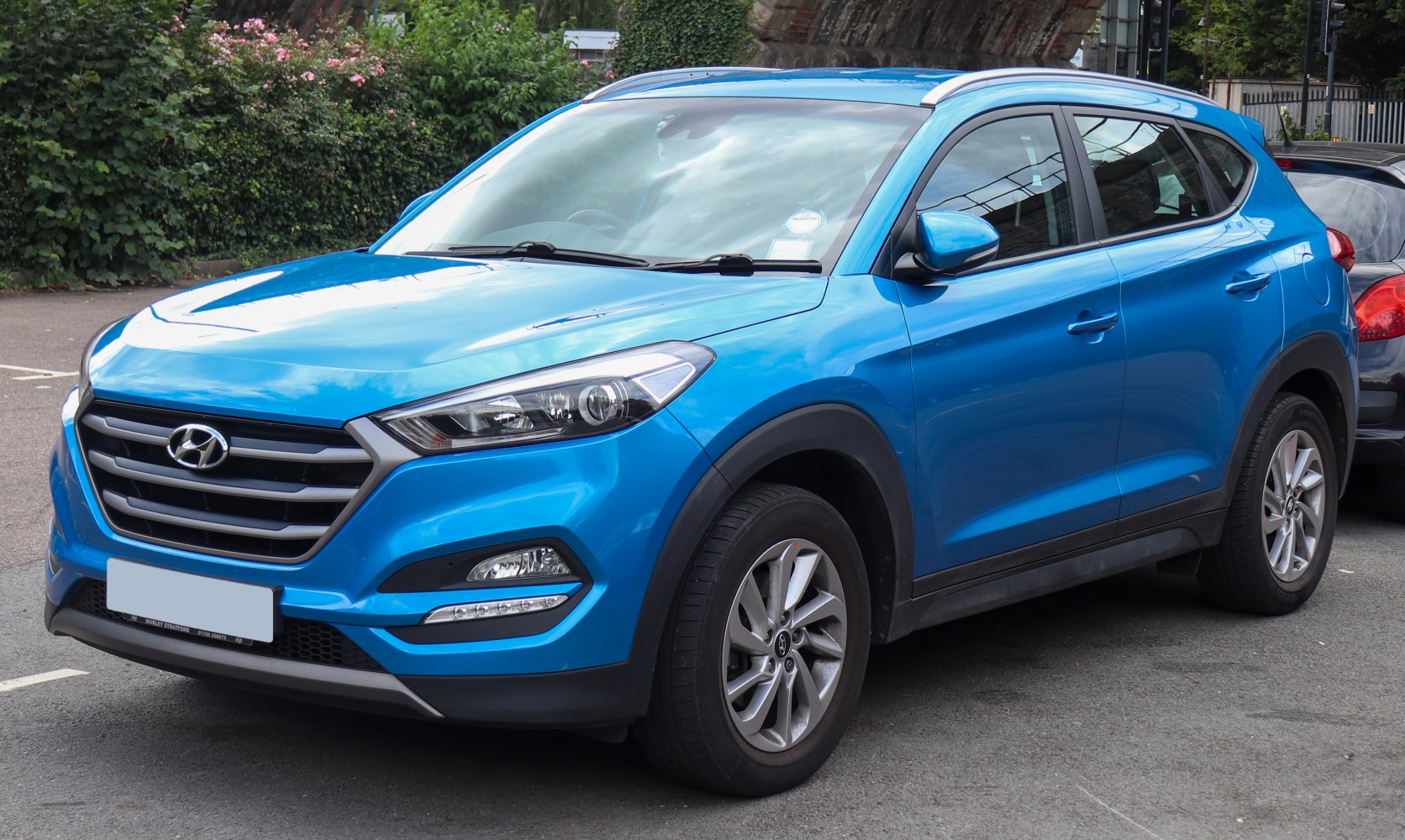 Blue compact SUV front grille, headlights, and side profile